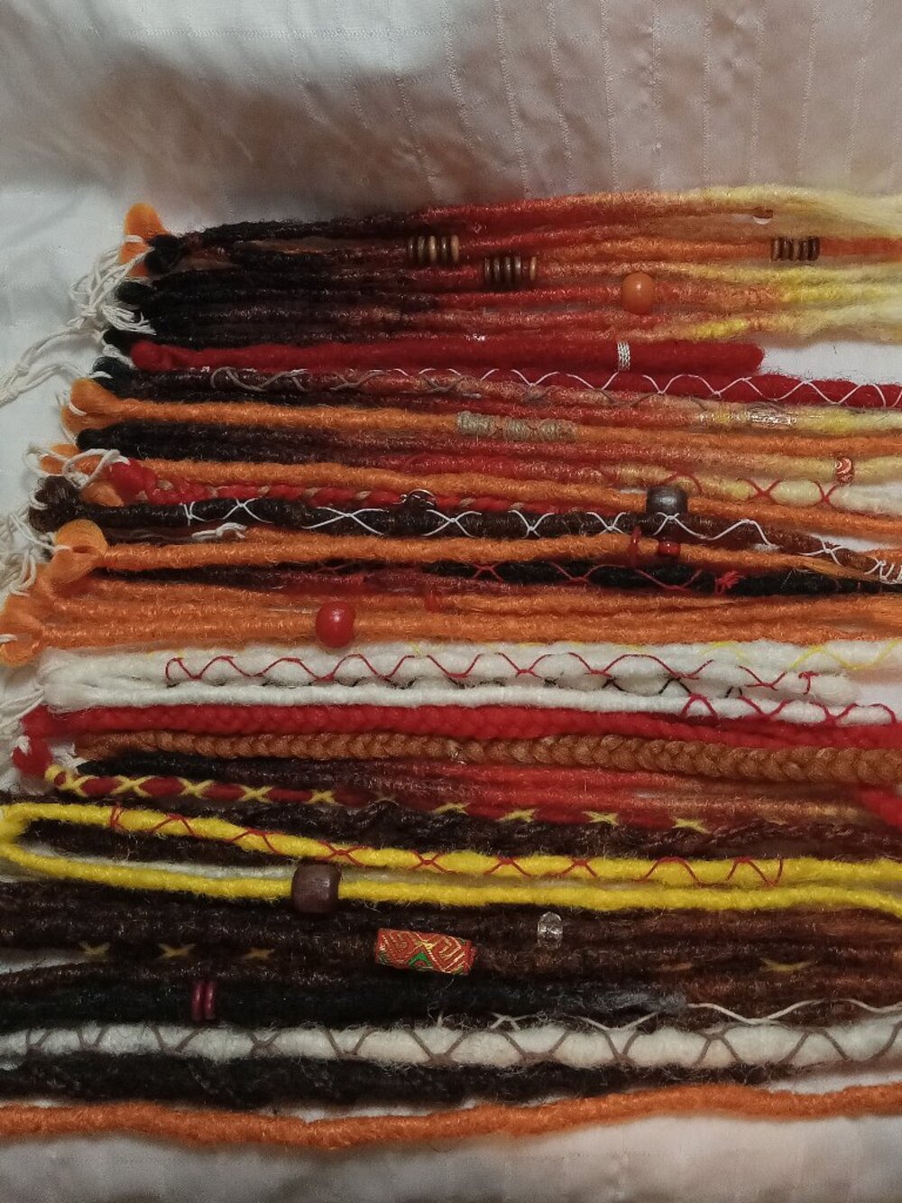 A full head of dreadlocks and braids, handmade from soft synthetic materials